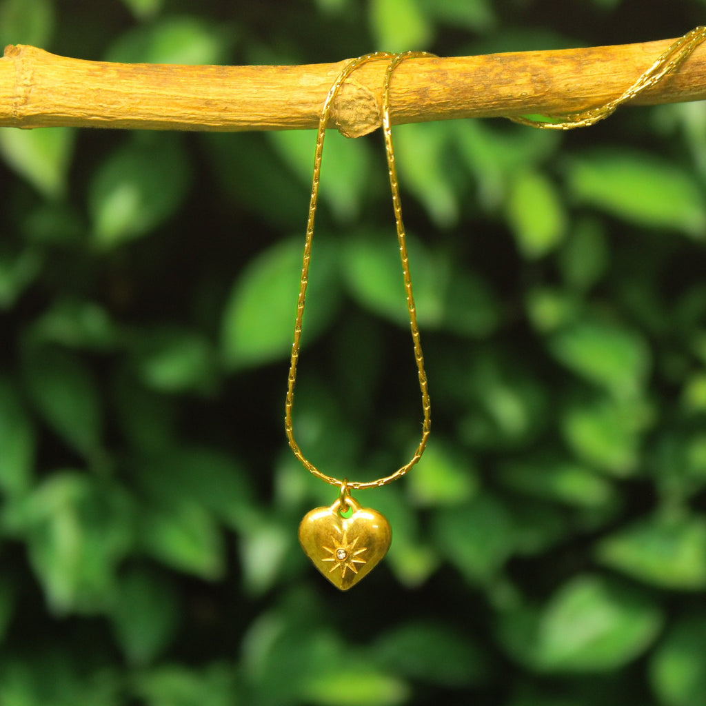 Ani tarnish gald chain with heart pendant hanging on a tree